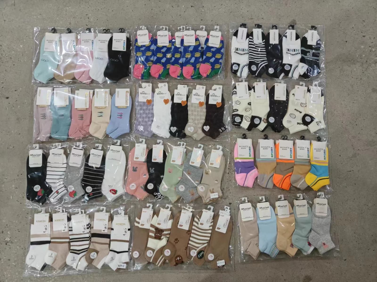 Textile and apparel assortment laid out for quality inspection on a factory floor
